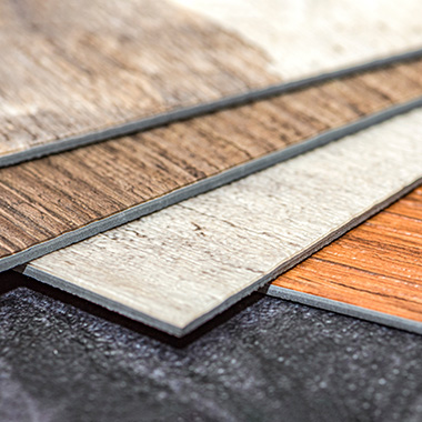 samples of three different vinyl tiles with wooden patterns on them